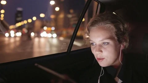 Young Woman Smiling While Using a Tablet in the Car Stock Footage 81015210