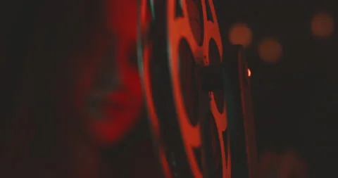 Young  woman smiling while using a vintage projector Stock Footage 203592844