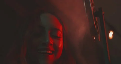 Young  woman smiling while using a vintage projector Stock Footage 203593099