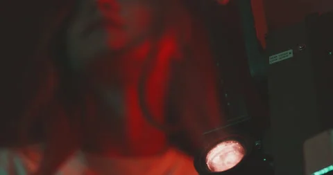 Young  woman smiling while using a vintage projector Stock Footage 203593374