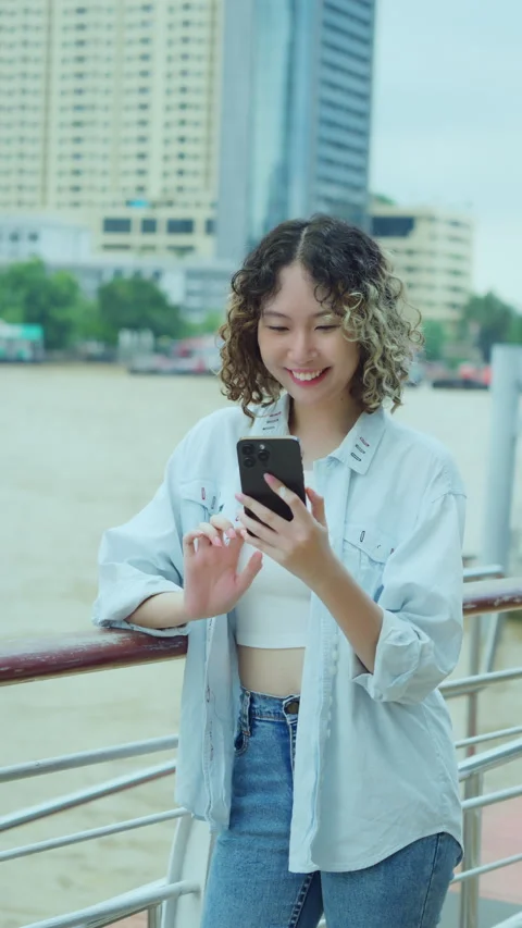 Young Woman Smiling While Using Smartphone Outdoors Stock Footage 291240848
