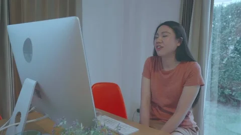 Young Woman Smiling While Using Computer at Home Stock Footage 313829578