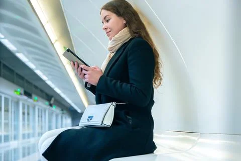 Young Woman Smiling While Using digital tablet in Modern Subway Station Stock Photos