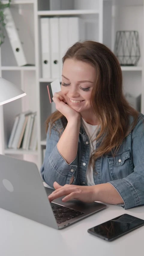 Young woman smiling while working remotely on her laptop in a modern home office Stock Footage 340922650