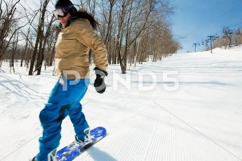 Young Woman Snowboarding