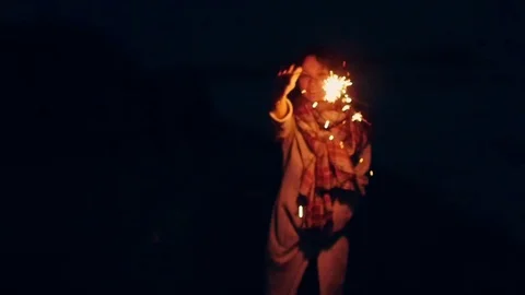 Young woman with sparklers. on the background of the sea Stock Footage