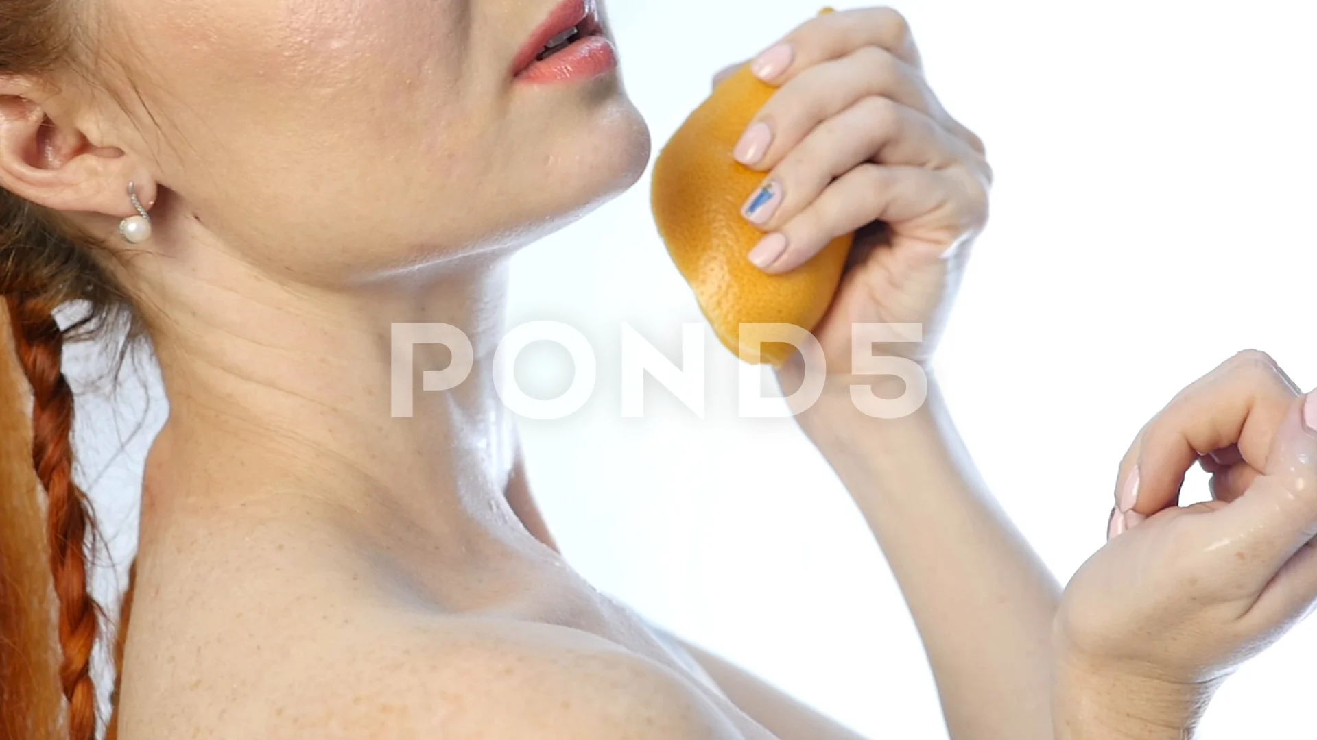 Young Woman Squeezing Orange on Neck and a Breast on a White Background,  Slow Motion Stock Video - Video of flowing, food: 126525221