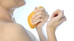 Young Woman Squeezing Orange on Neck and a Breast on a White Background,  Slow Motion Stock Video - Video of flowing, food: 126525221