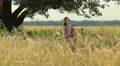 Young woman stand and walk in the wheat and sunset background HD Footage