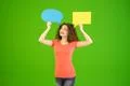 The young woman stand with a dialog signs on the green background Photo