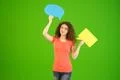 The young woman stand with a dialog signs on the green background Photo