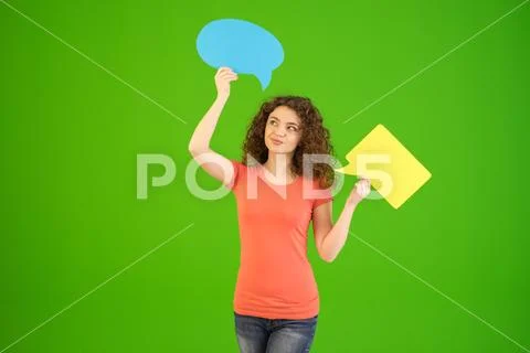 The young woman stand with a dialog signs on the green background Stock Photos