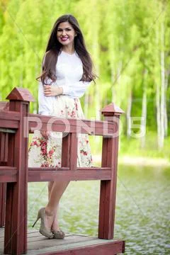 Young woman standing on the bridge Stock Photos