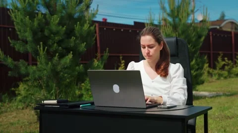 Young woman starting a remote work day outdoors Stock Footage 337829836