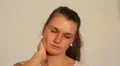 Young woman with a stiff or sore neck HD Footage