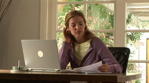 Young woman stressed while working at home with laptop Stock Footage