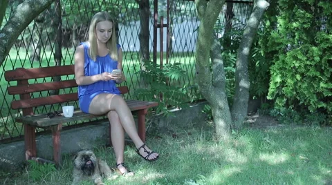 Young woman stting on the bench and texting  Stock Footage 59150047