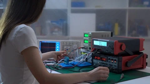 Young woman student in physics / electronics laboratory Stock Footage 87864339