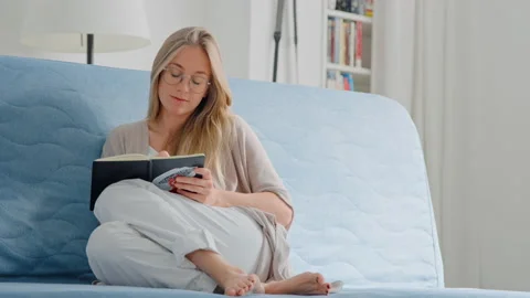 Young woman study on sofa with notebook and phone Stock Footage 130712246