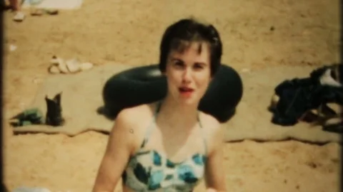 young woman sunbathing at the beach 1950... | Stock Video