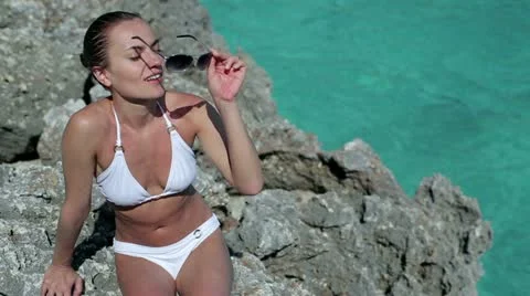 Young woman sunbathing on the beach Stock Footage