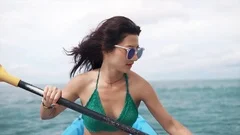 Young pretty woman in sunglasses rowing , Stock Video