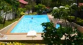 Young Woman Swimming in a Private Pool next to Luxury Villa in Thailand. Slow HD Footage