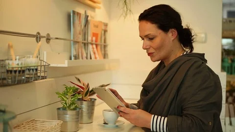 Young woman with tablet computer sitting in cafe Stock Footage 70865151
