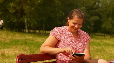 Young woman with tablet computer. smiling and laughing. Stock Footage 24759389
