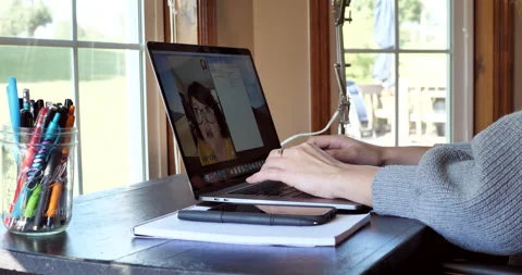 Young woman takes notes while video conferencing. Video stock 141231038