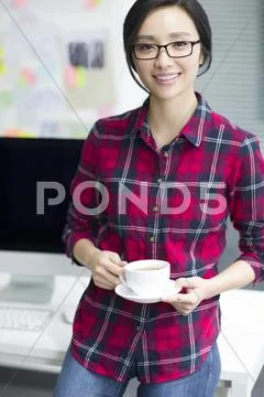 Young woman taking a coffee break Stock Photos
