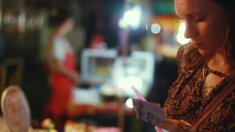 Young woman taking donuts from the shelf of walking street market. 1920x1080 Stock Footage