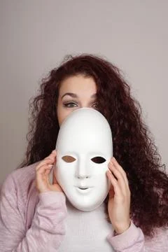 Young woman taking off mask Stock Photos