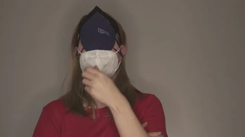 Young woman taking off multiple face masks Stock Footage 146698637