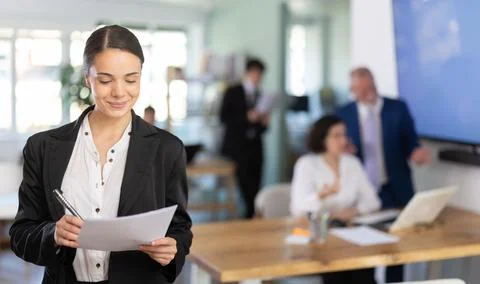 Young woman taking notes in document Stock Photos