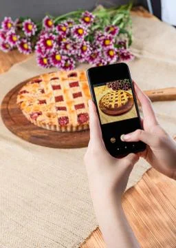 Young woman taking photo of food with smartphone Stock Photos