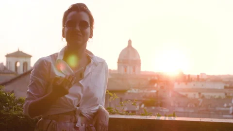 Young woman talking to camera in front of Rome cityscape from high balcony Vídeo Stock 237006153