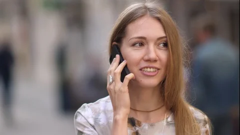 Young woman talking on the mobile phone outdoor Stock Footage