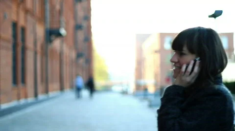 Young woman talking on the mobile while walking in the city, steadicam shot Stock Footage 876602