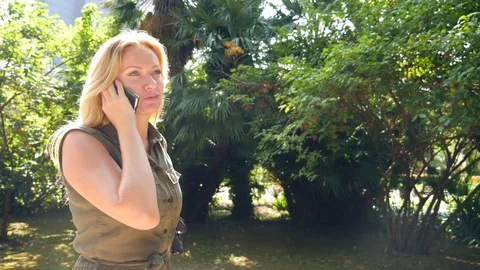 Young woman is talking on the phone . 4k, slow-motion Stock Footage