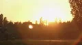 Young woman talking on phone while walking with baby in stroller, magic hour HD Footage