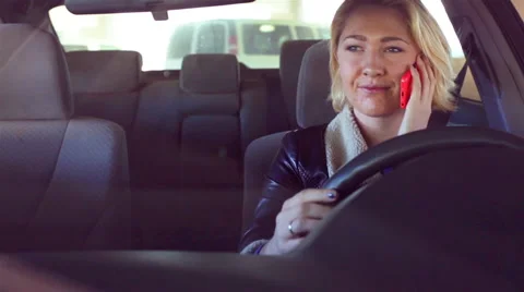 A Young Woman Talks on Phone While Driving Stock Footage 46016566