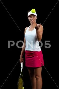 Young woman on a tennis practice. Beginner player holding a racket, learning Stock Photos