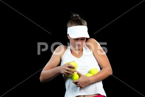 Young woman on a tennis practice. Beginner player holding a racket, learning Stock Photos