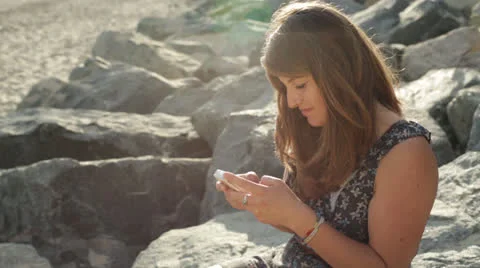 Young Woman Texting on the Beach Stock Footage 24791743
