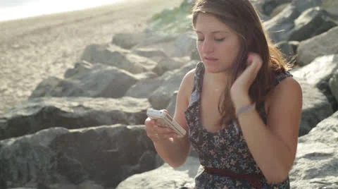 Young Woman Texting on the Beach Profile Stock Footage 24772504