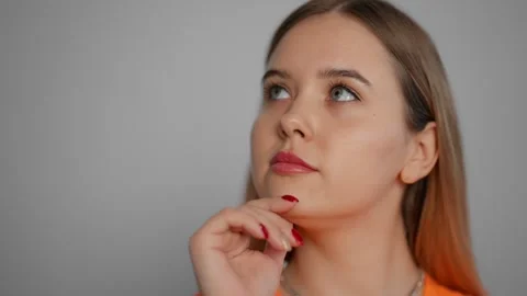 Young woman thinking to solve a problem. Pensive girl thoughtfully at idea hold Stock-Footage 267234645
