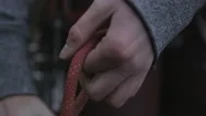 A Young Woman Threads The Rope Through Her Climbing Safety Device Stock Footage