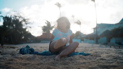 Young woman throw sand on the beach Stock Footage