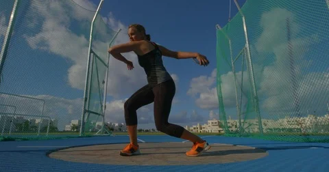 A young woman Throwing the Discus in Slow Motion. Stock Footage